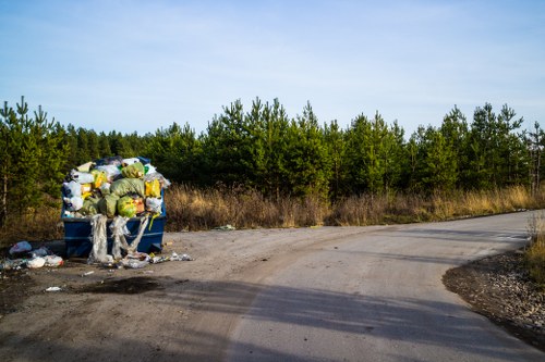 Team preparing garden clearance equipment at site entrance
